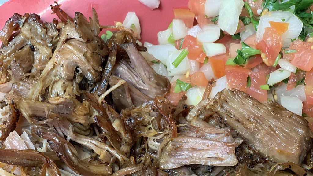 30. Carnitas Plate · Traditional Mexican Pulled pork  with rice, beans and corn or flour tortillas.