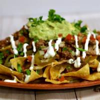Super Nachos a La Carte · Served with choice of meat, beans, cheese guacamole, jalapeno and sour cream.