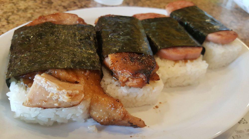 SPAM MUSUBI (2) · One piece of grilled spam rested on a bed of steamed rice, coated in musubi sauce, and wrapped in seaweed. Comes with 2 pieces