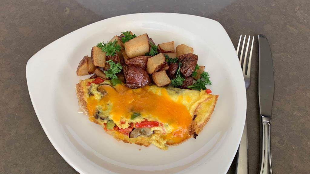 Build Your Own Omelet · Choose 3 items: chicken sausage, pork sausage, roasted mushrooms, caramelized onions, oven dried tomato, cheddar cheese, goat cheese, applewood smoked bacon, or sautéed spinach. Breakfast potatoes served on the side.
