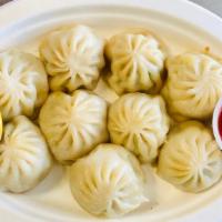 Chicken Chilli Momo · Medium. Chicken momo toasted with bell pepper, onion and chilli sauce.