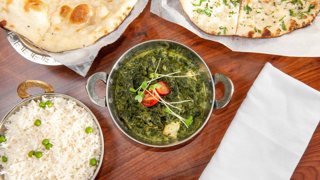 Palak Paneer · Cottage cheese tossed in a thick gravy made from puréed spinach and seasoned with garlic and Indian spices.