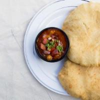 Chana Bhatura · Garbanzo beans cooked in special blend of spices with puffed leavened bread.