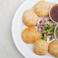 Pani Poori · 8 crispy puffed wafers made from semolina, served with spicy mint water and chutneys.