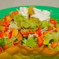 Taco Salad · Crispy flour tortilla shell filled with meat, rice, beans, sour cream, lettuce, guacamole, t...