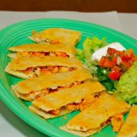 Mexican Quesadillas · Large flour tortilla filled with cheese, meat, and cooked on the grill for a crispy taste. s...