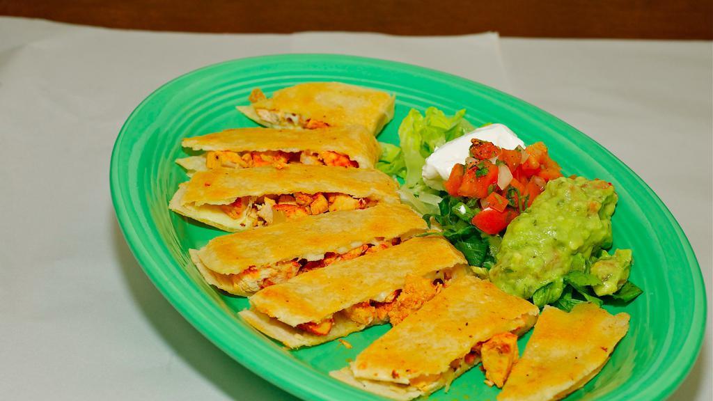 Mexican Quesadillas · Large flour tortilla filled with cheese, meat, and cooked on the grill for a crispy taste. served with sour cream, guacamole, and pico de gallo.