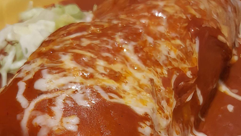 Enchiladas Verdes · Two chicken enchiladas, covered with green tomatillo sauce and topped with cheese and sour cream.