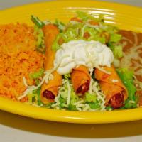Taquitos De Pollo · Shredded chicken wrapped in corn tortillas, deep fried and topped with sour cream, lettuce, ...