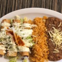 Chicken Flautas Platillo · 3 chicken flautas served with rice, beans, topped with lettuce, sour cream, cheese, onions a...