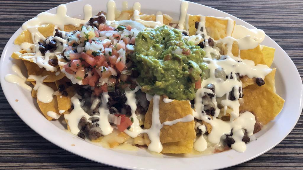 Nacho Fries · Your choice of meat, refried beans, cheese, sour cream, pico de gallo and guacamole.