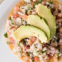 Tostada Ceviche · Raw Fish cooked with lemon topped with avocado.