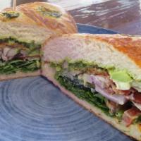 Heavenly Bacon Empire Sandwich · Garnished with mayonnaise, pesto sauce, avocado, arugula, cucumber, tomatoes, red onions, mo...