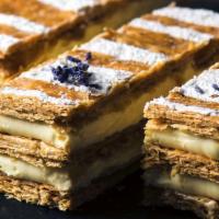 NAPOLEON · crispy layers of puff pastry filled with pastry cream and decorated with powdered sugar