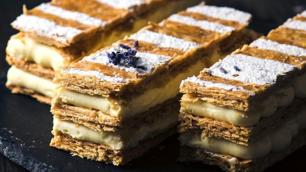 NAPOLEON · crispy layers of puff pastry filled with pastry cream and decorated with powdered sugar