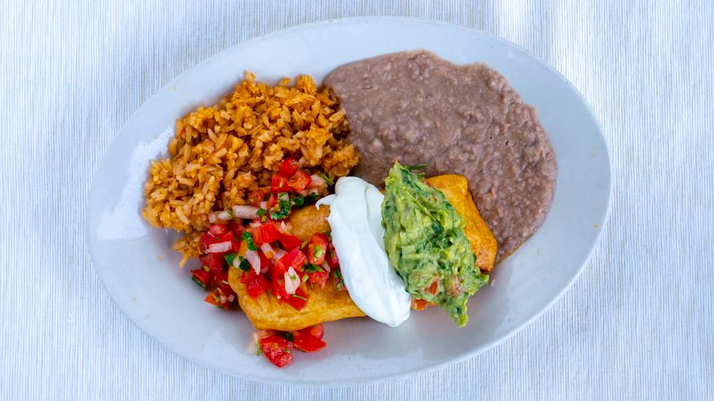 Chimichanga · A large tortilla stuffed with your choice of meat, then fried till golden brown and crispy. We serve it alongside rice, beans, and top it with our house-made guacamole, sour cream, and pico de gallo.