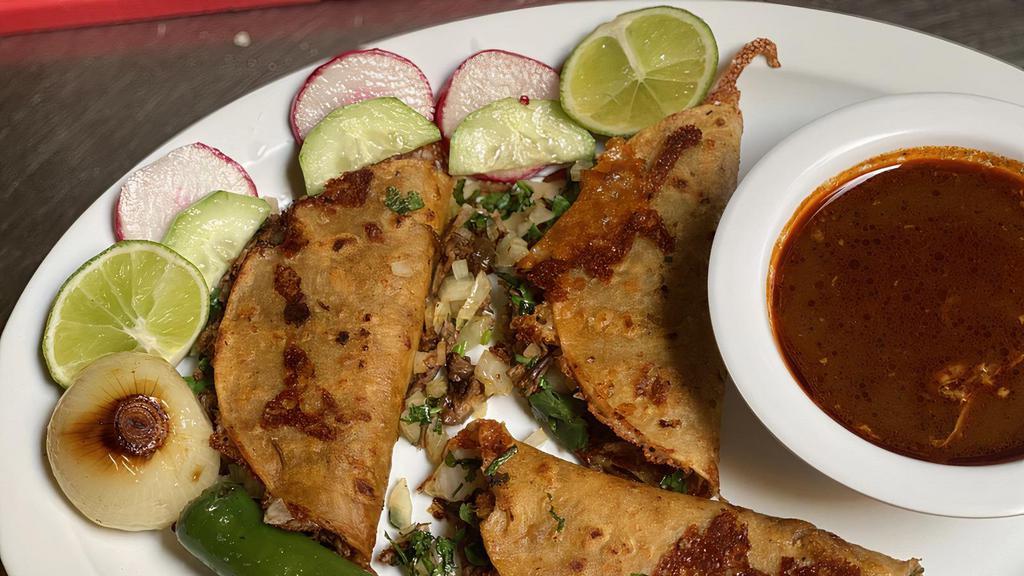 Quesabirria  · Tortilla dipped in birria sauce. Then cooked until crispy, with a cheesy and birria filled center. Topped with cilantro and onions. Includes a side of Consome, grilled onion, grilled serrano pepper, lime, and radishes.
