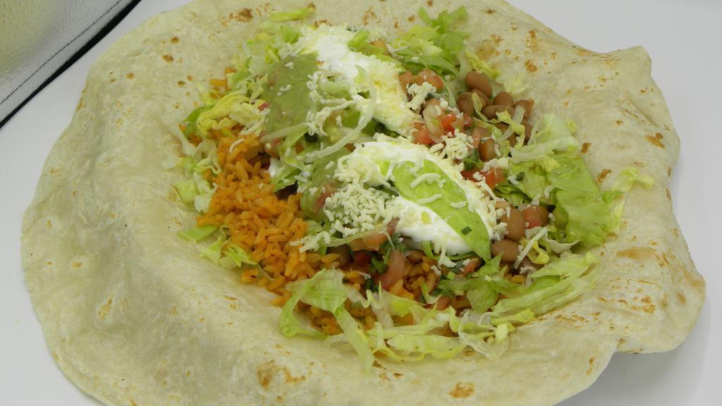Veggie Burrito · Served with rice and beans, lettuce, pico de gallo, cheese, sour cream, and guacamole.