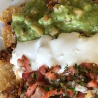 Super Nachos · Served with your choice of meat, cheese, guacamole, sour cream, pico de gallo & re-fried bea...