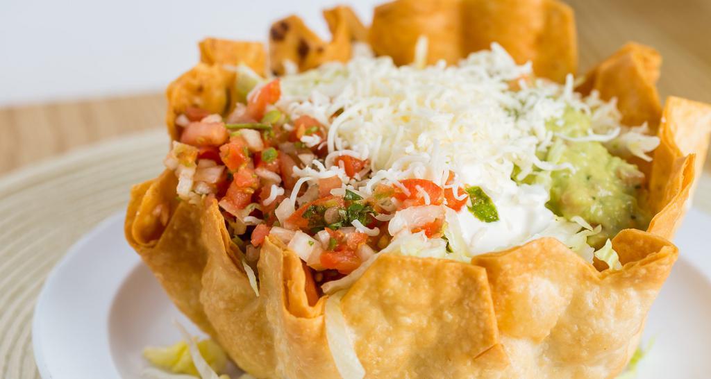 Taco Salad · Served with choice of meat, fresh lettuce, beans, rice, guacamole, sour cream, cheese & pico de gallo.
