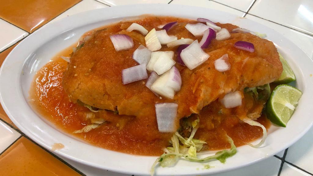 Torta Ahogada · Torta smothered with spicy diabla salsa.