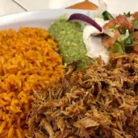 Carnitas Plato · Served with rice refried beans lettuce guacamole sour cream and pico de gallo. with your cho...