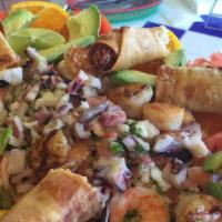 Seafood Appetizer · Grilled shrimp, octopus, ceviche, surrounded with taquitos. Perfect to share!