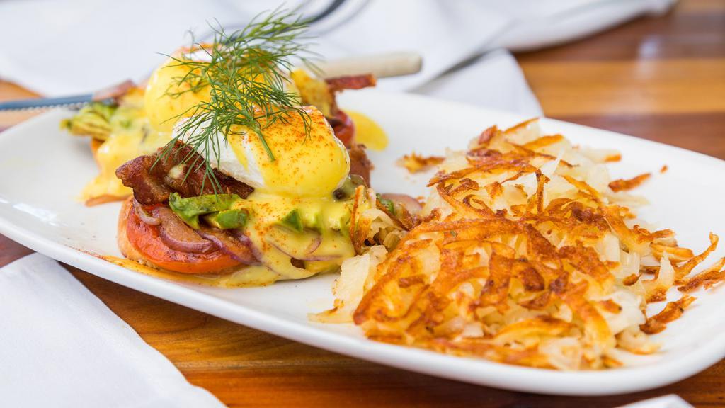 California Benedict · Grilled tomato, onion, bacon , two poached eggs on sourdough baguette. topped with hollandaise.