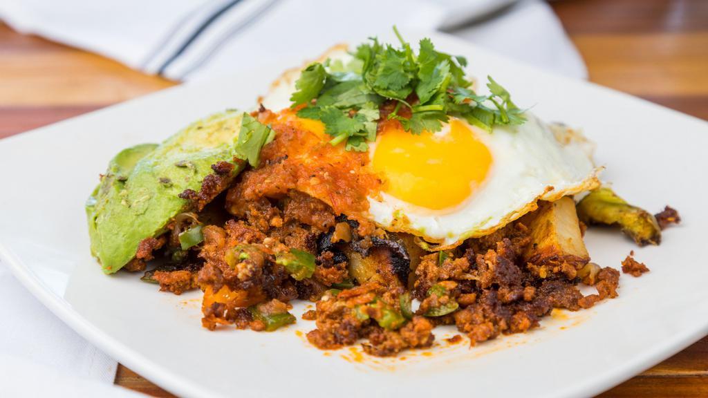 Chorizo Skillet · Chorizo, onion, fresh jalapeño, over house made seasoned potatoes, Cheddar Cheese, jack cheese, topped with two eggs any style, salsa and avocado. Finished with cilantro.