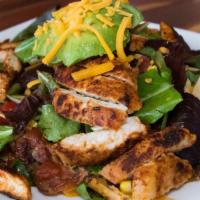 Cajun Chicken Salad · Garden mix spring salad, grilled chicken, bacon, corn, cherry tomato, cheddar cheese and cri...