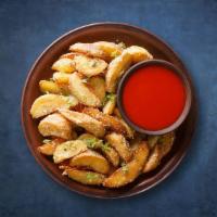 Potato Wedges · Wedges of large potatoes unpeeled and then golden deep fried.