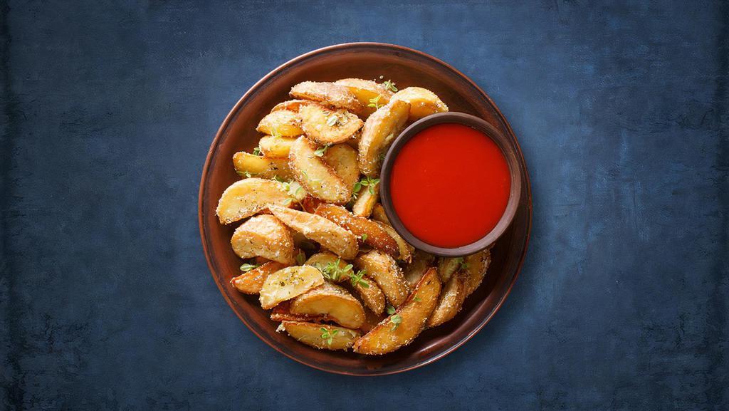 Potato Wedges · Wedges of large potatoes unpeeled and then golden deep fried.