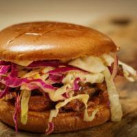 Pulled Pork Sandwich · Pulled pork topped with slaw, pickles, BBQ sauce on a brioche bun.
