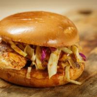 Pulled Chicken Sandwich · Pulled chicken topped with slaw, pickles, BBQ sauce on a brioche bun.