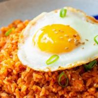 Kimchi Fried Rice · Fried rice with kimchi, bulgogi beef, and spam topped with fried egg and dried seaweed