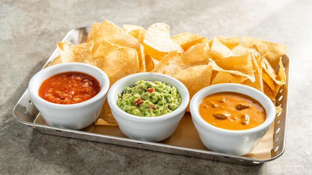 Dip Trio · Choose any three. Skillet queso, white queso, fresh salsa, fresh guacamole or house-made ranch. Served with warm corn tostada chips.