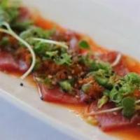 Cajun Tuna Sashimi · Slice of seared tuna w/jalapenos, tobiko, green onion and spicy ponzu.