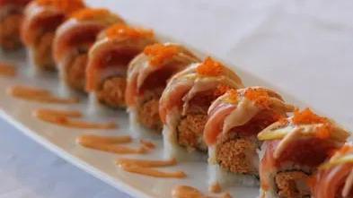 Island Roll · Inside: shrimp tempura and spicy crab, outside: spicy tuna, salmon, slice of lemon and fish egg.