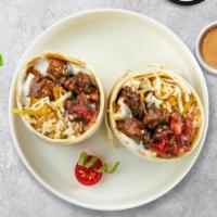 Carnitas Burrito · Grilled sirloin steak wrapped in a warm tortilla with sour cream, salsa, cheese, and spanish...