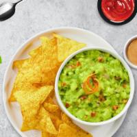 Guac My World · A heaping scoop of fresh guacamole and warm tortilla chips