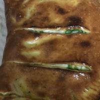 Vegetarian Special Calzone · Mushrooms, onions, bell peppers, sliced tomatoes, mozzarella, ricotta cheese, black olives.