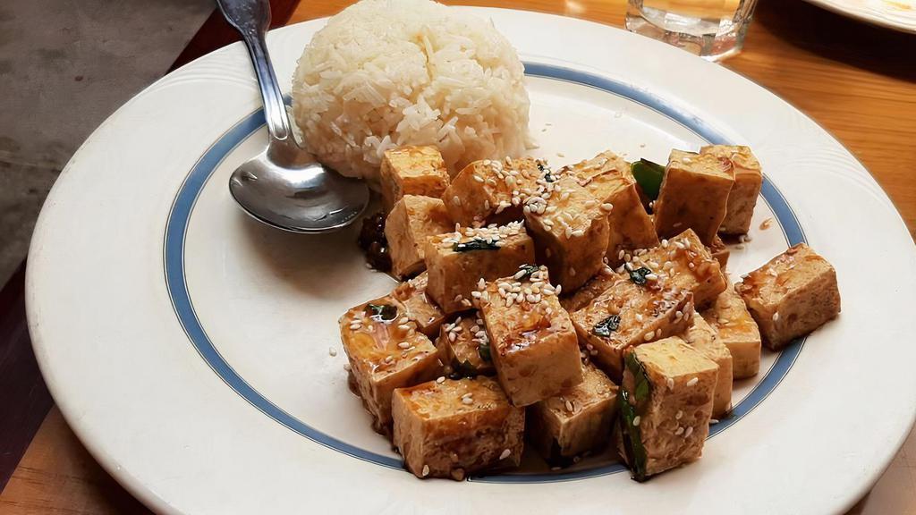 Sesame Orange Tofu · Deep fried tofu in spicy sweet and tangy sauce, topped with roasted sesame seeds.