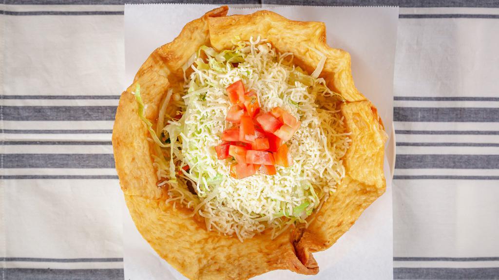 Taco Salad · Choice of meat, beans, guacamole, sour cream, cheese, lettuce, tomatoes, cilantro and onions in a crispy flower bowl.