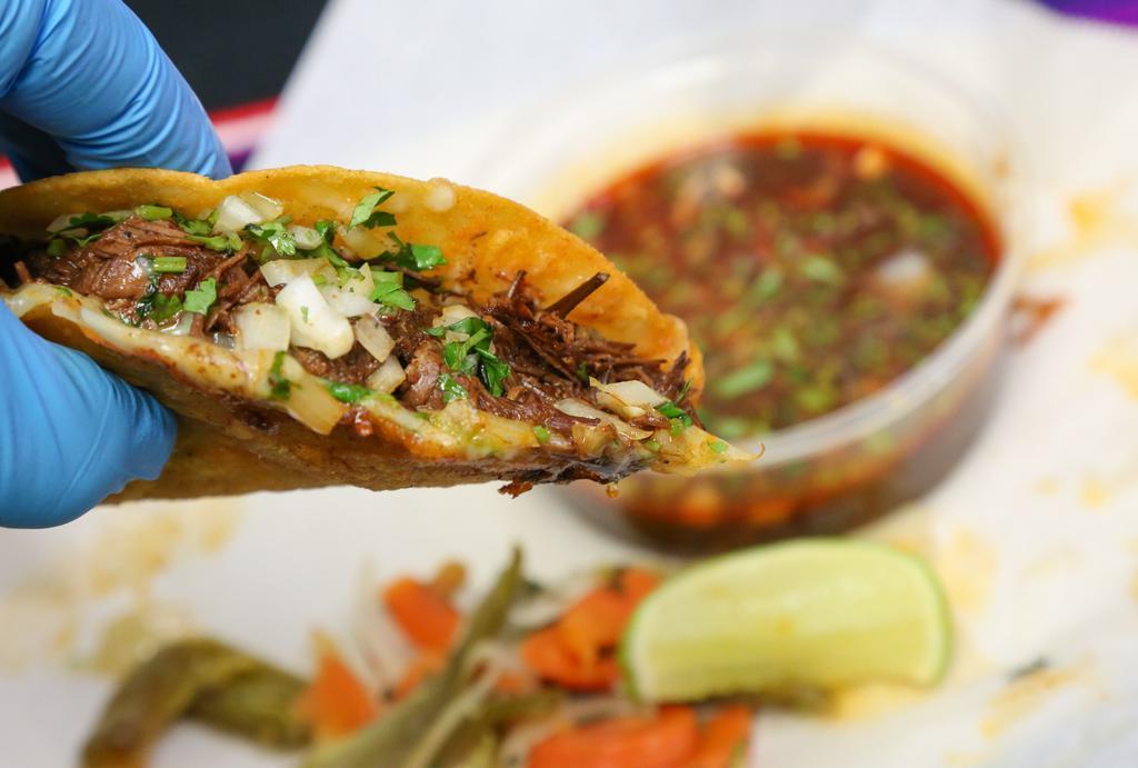 Quesabirria · Melted cheese on a corn tortilla, marinated beef, onions, cilantro. Consome Dip and pickled carrots, onions, and jalapeños on the side.