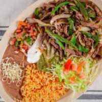 Ranchero Plate · Slices of steak  grilled with onios and 
jalapeños, rice, beans, pico de gallo, guacamole, s...