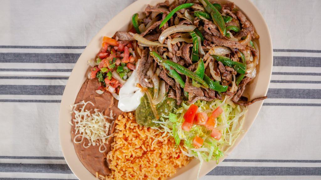 Ranchero Plate · Slices of steak  grilled with onios and 
jalapeños, rice, beans, pico de gallo, guacamole, sour cream, lettuce