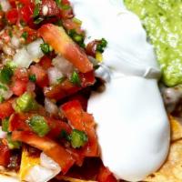 Super Nachos · Corn chips, cheese, guacamole, sour cream, salsa and choice of meat.