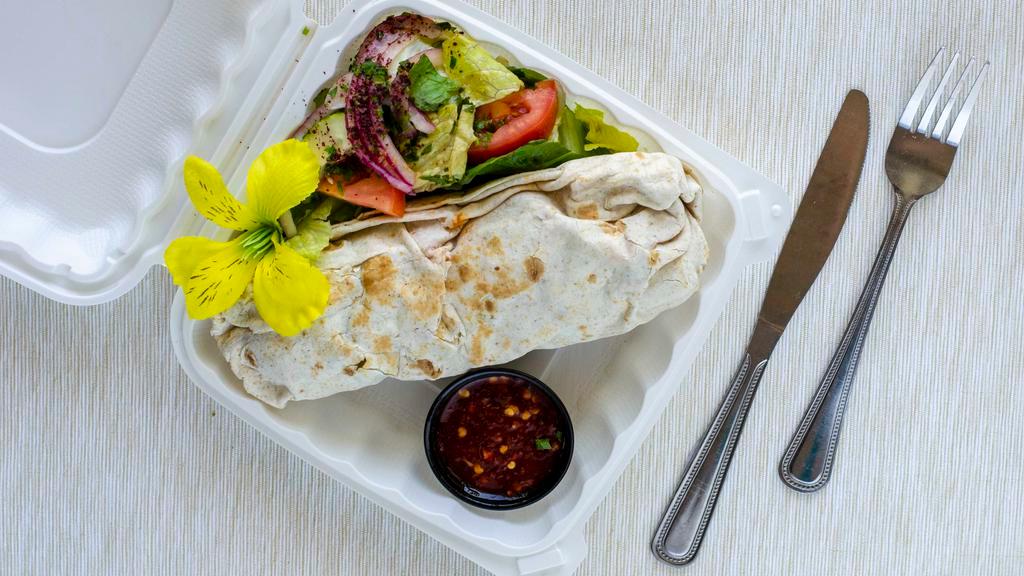 Chicken Shish Kabab Wrap · Marinated grilled chicken cubes with tomatoes, lettuce, onions, pickled vegetables, tahini and garlic sauce.