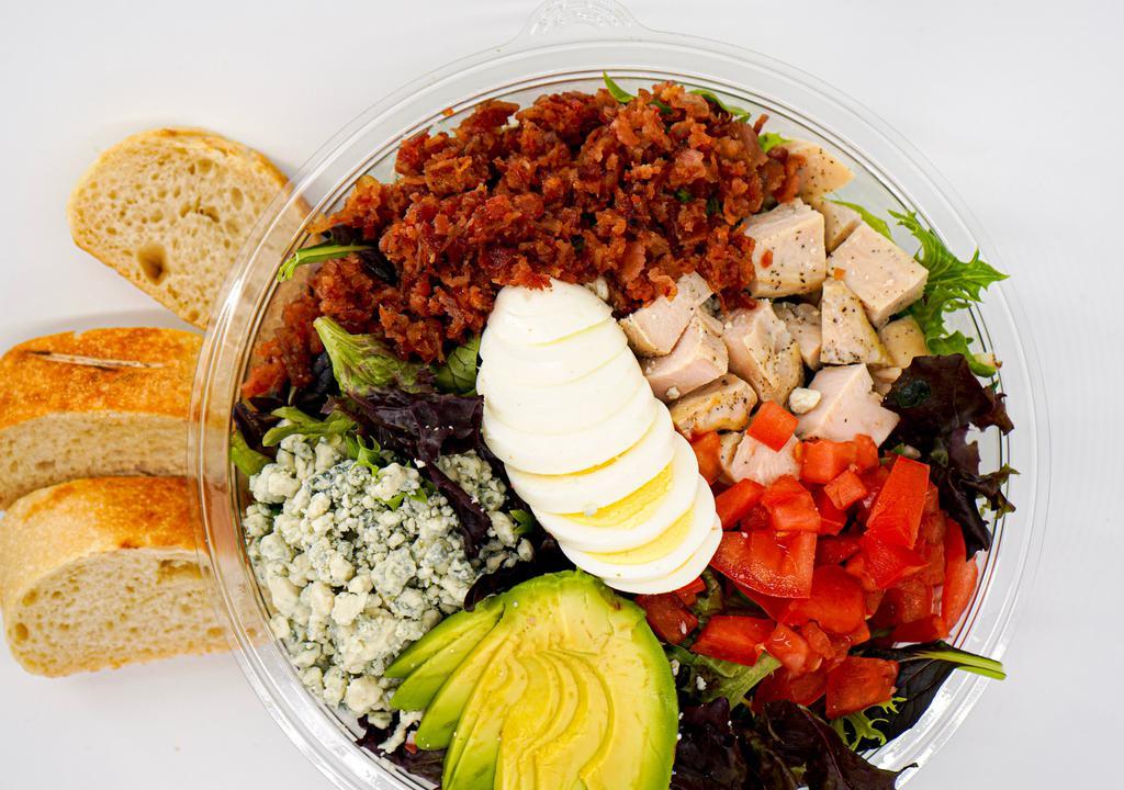 Cobb Salad · Chopped romaine and spring mix, cherry tomatoes, crisp bacon, sliced hard-boiled egg, avocado, grilled chicken, crumbled gorgonzola and blue cheese dressing