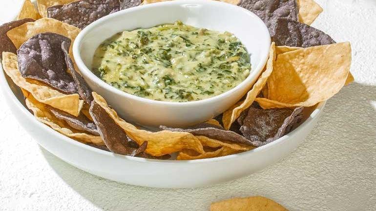 Spinach Artichoke Dip · Served hot with housemade blue & white corn tortilla chips.
